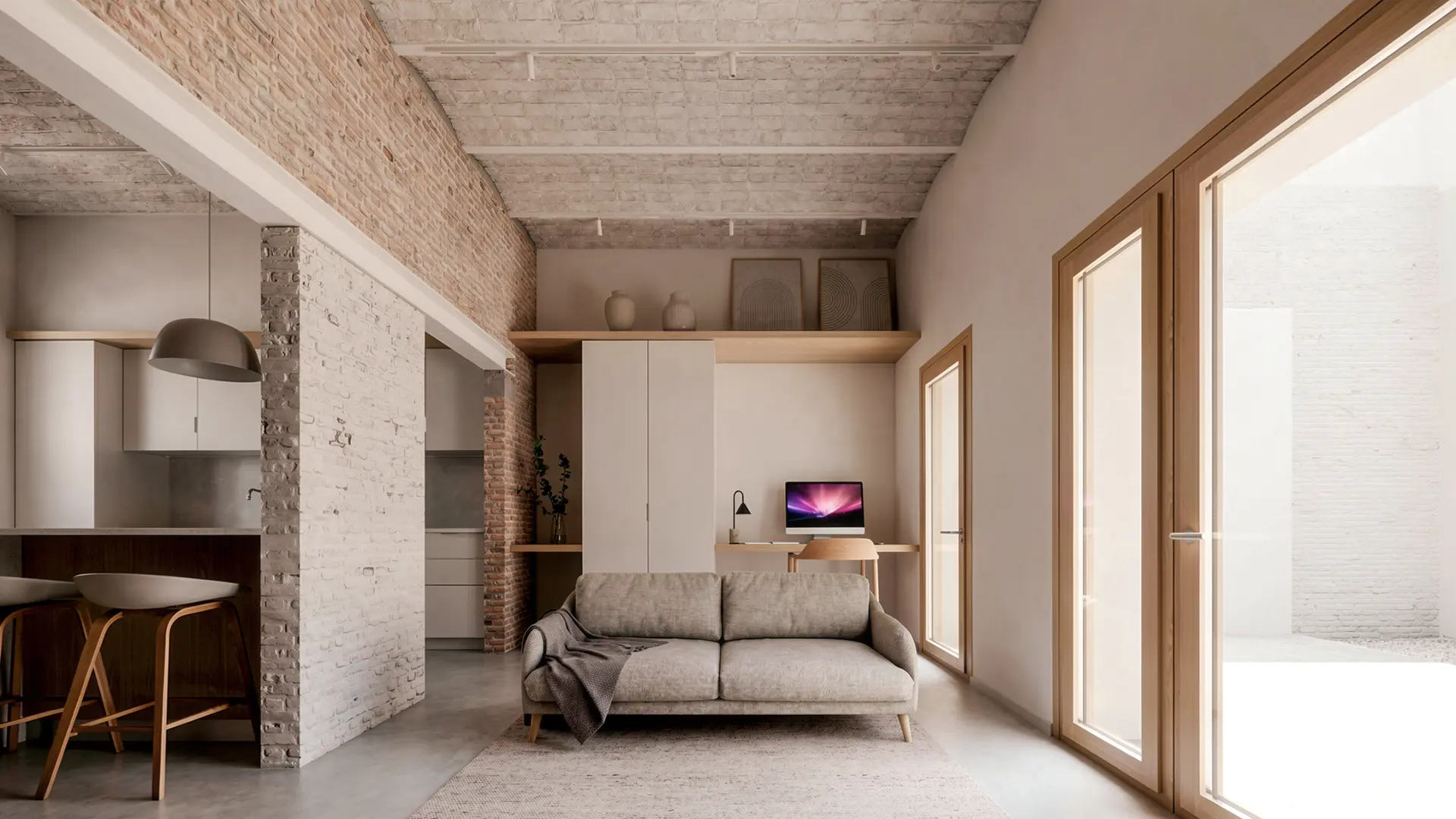 Salón con zona de trabajo integrada en vivienda reformada en Badalona, con ladrillo antiguo recuperado visto, techo de bóveda catalana, mobiliario lacado en blanco y grandes carpinterías de madera al patio. Proyecto de Tova Arquitectura