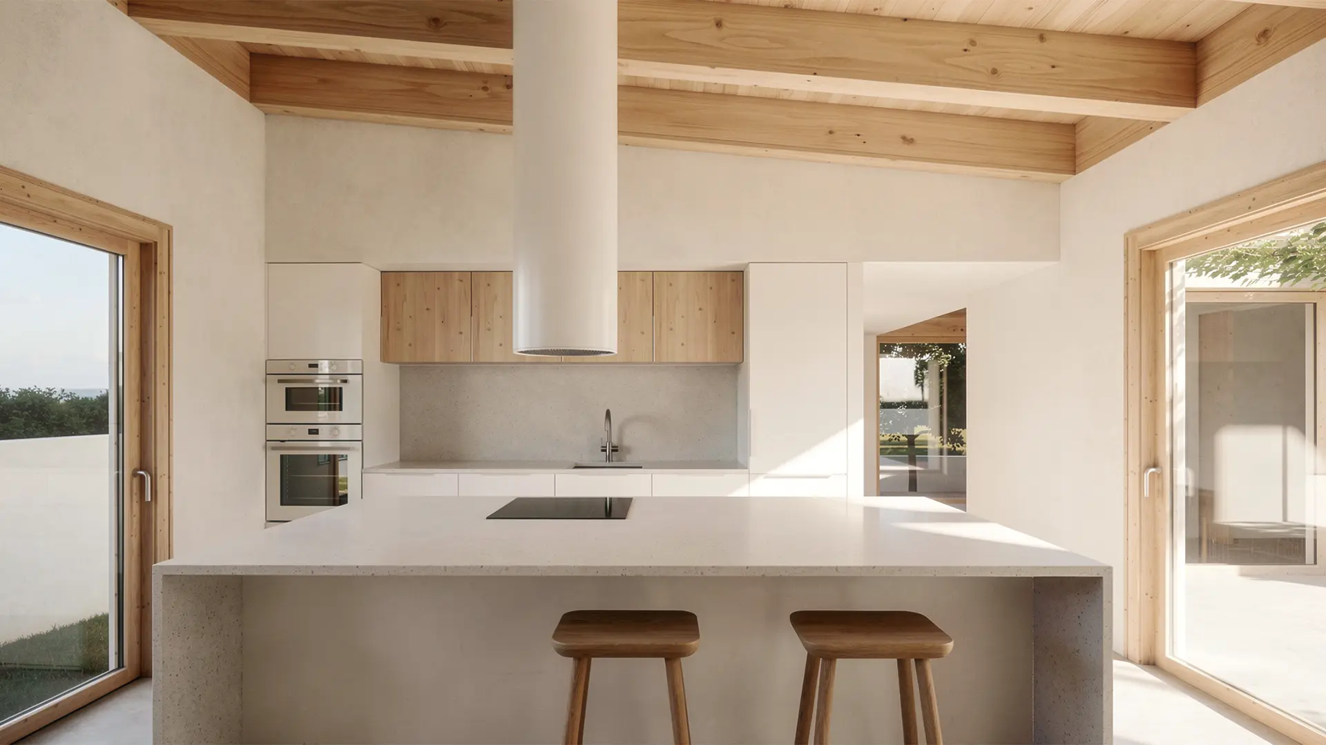 Cocina de vivienda unifamiliar de obra nueva en Cardedeu, con isla de microcemento, muebles de madera natural, techo de vigas vistas y campana cilíndrica lacada en blanco. Proyecto de Tova Arquitectura.