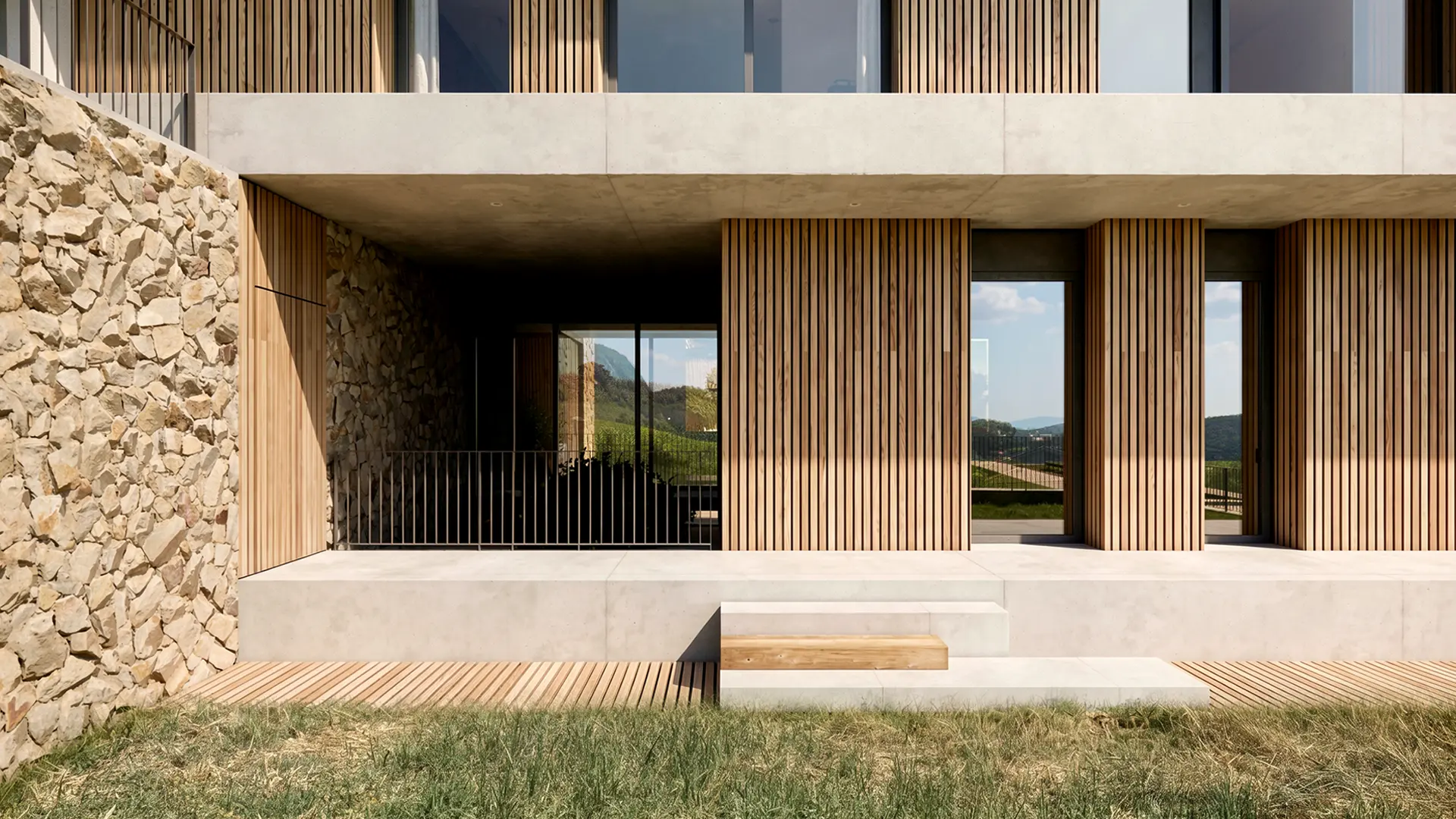 Detalle de fachada de vivienda unifamiliar de obra nueva en Cardedeu, con lamas de madera verticales, hormigón visto, muro de mampostería de piedra natural y tarima de madera con vistas al paisaje del Vallès Oriental. Propuesta de diseño de Tova Arquitectura